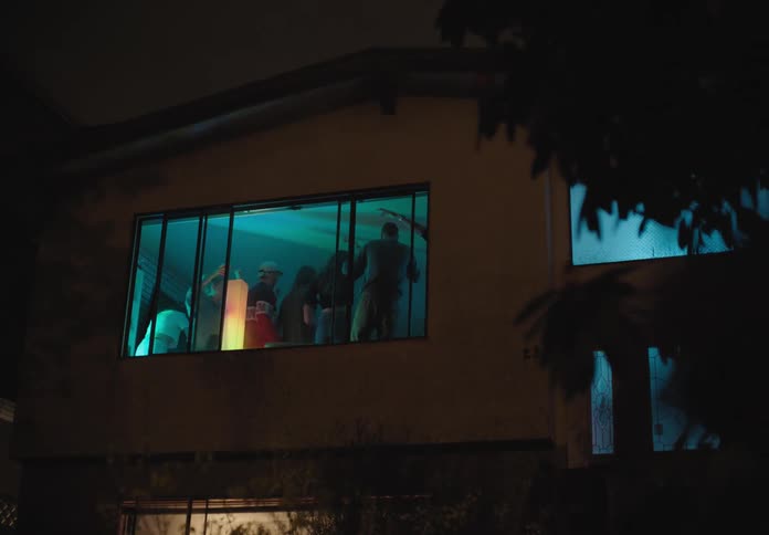A group of people dance inside a house