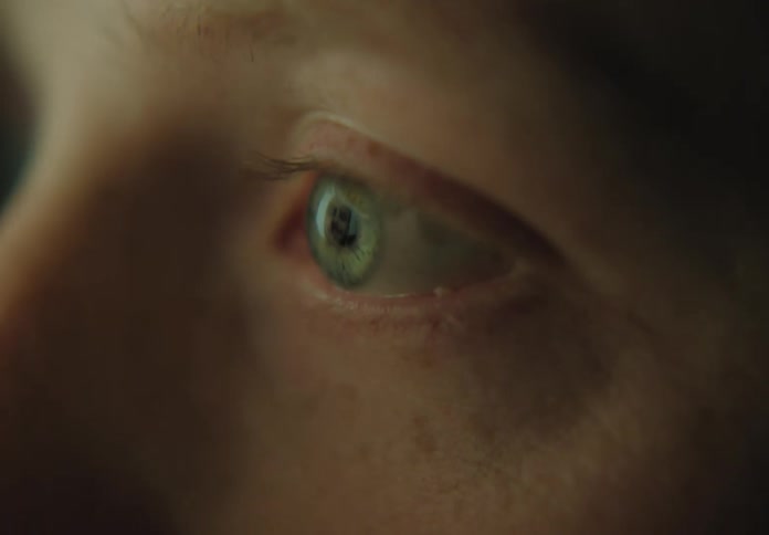 A white person moves their eye