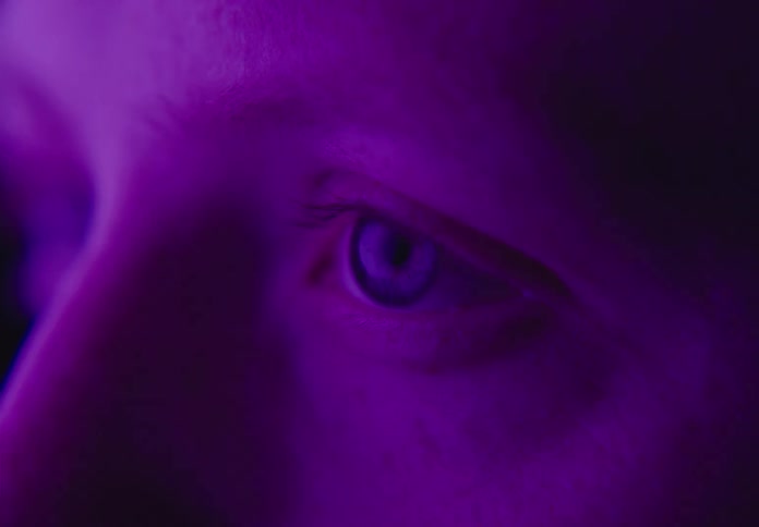 A white female opens her eyes