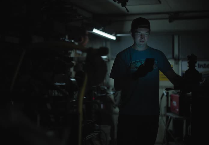 A man is talking on a cell phone in a room