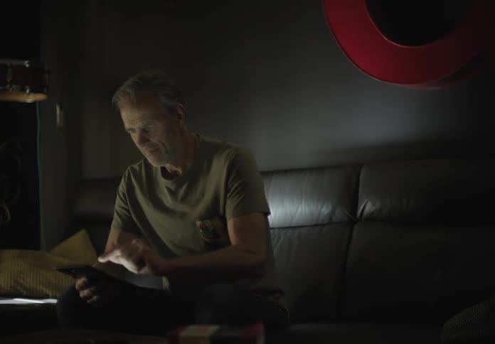 The man looks through his smart phone