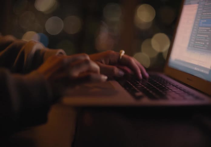 A person typing on a laptop
