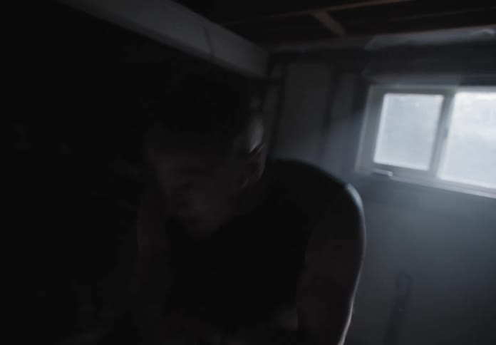 A white man boxing in the basement of a home