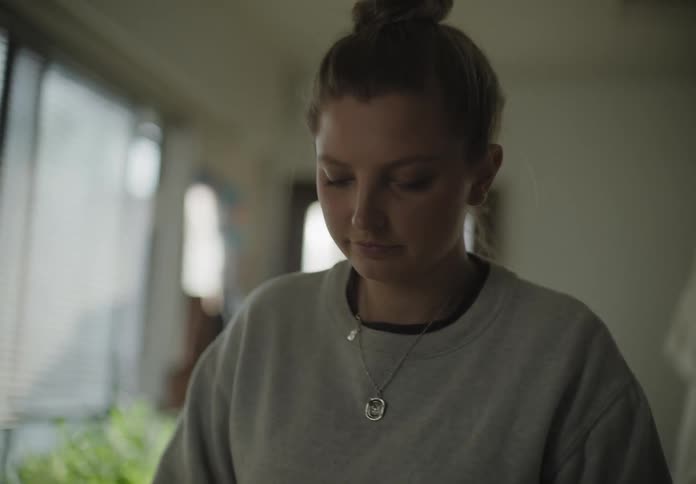 A woman in the kitchen kneading dough