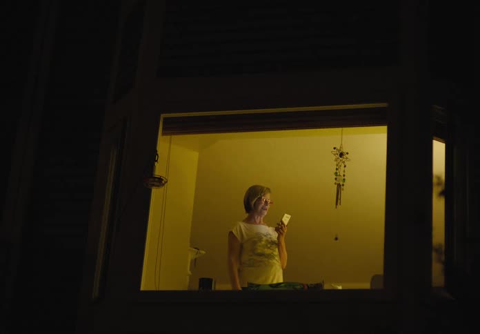Woman on video call from her apartment at night