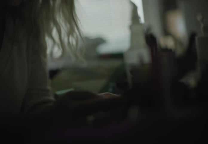 A woman sitting at a table using a smart phone