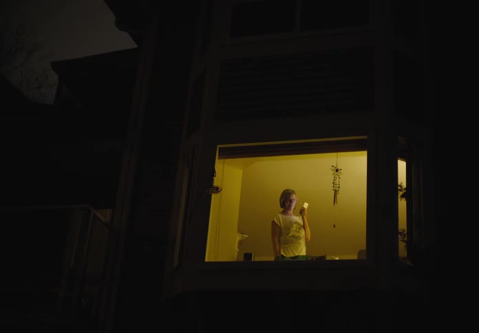 A woman is talking on a cell phone at night