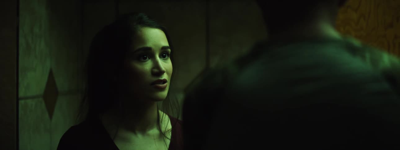 A woman shakes her head clearly upset as she talks with a man