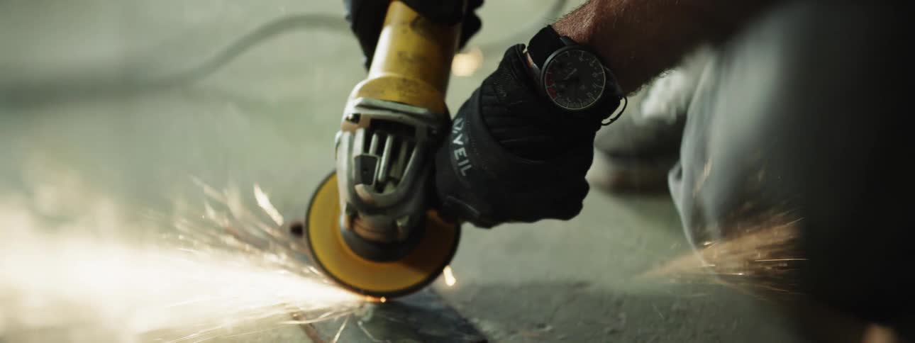 Sparks fly as a man uses a tool