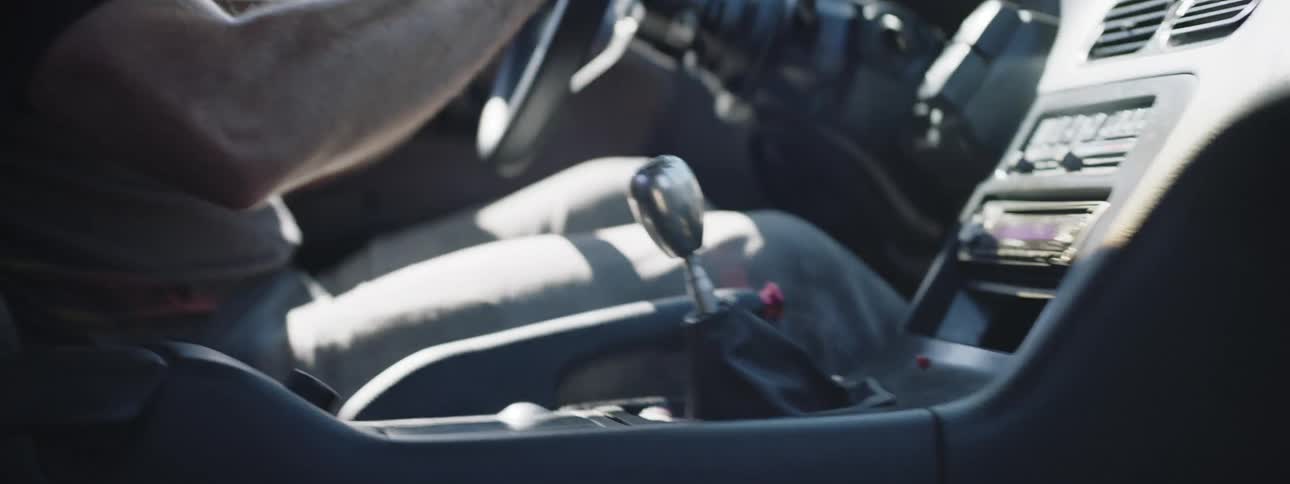 Man driving quickly shifts gears