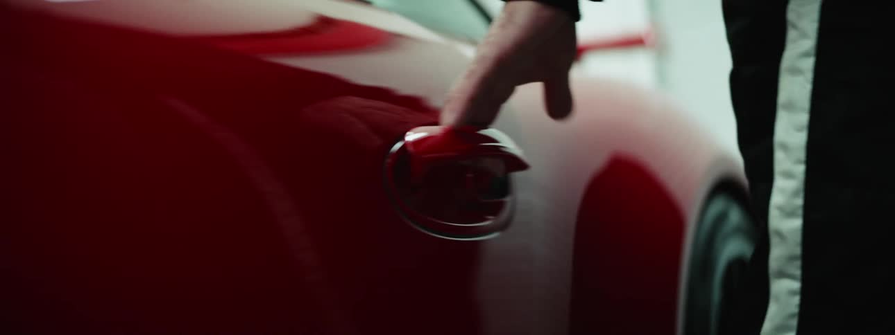 A white man opens a car door