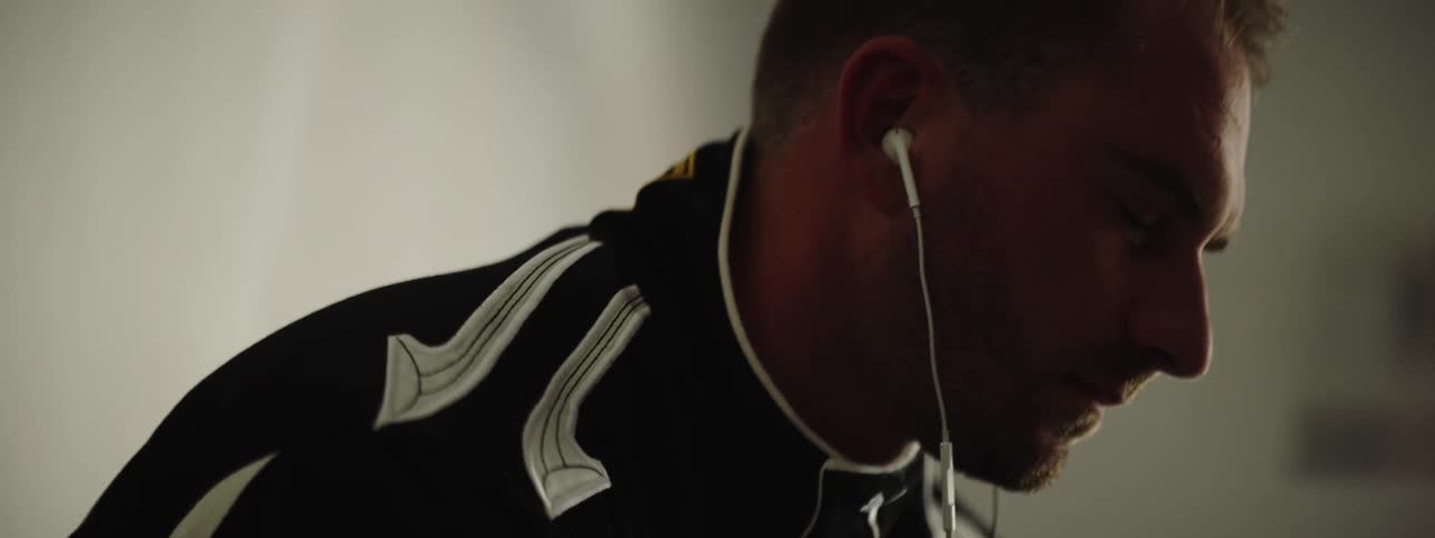 A man closes his eyes and moves to a beat as he listens to music