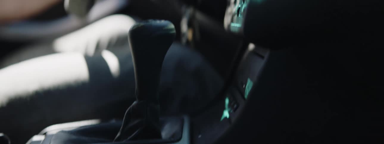 A man shifts as he races his car