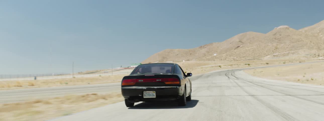 A person is driving a car in a rural area