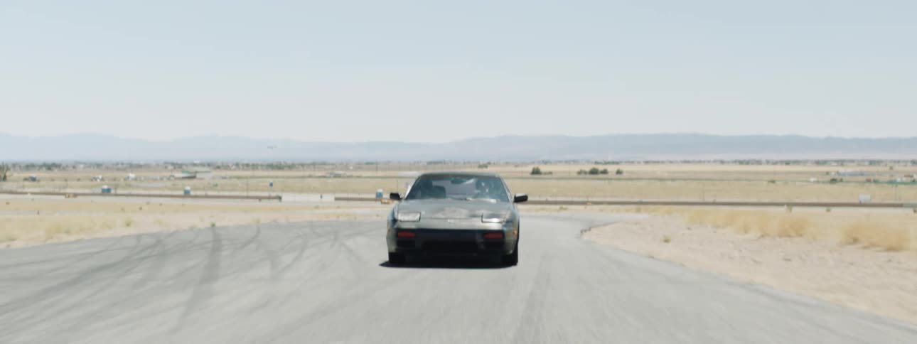 A person races a car around a road