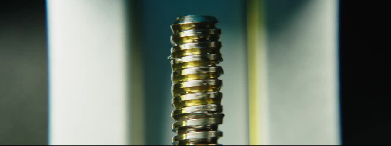 A tool bit spirals up and lengthens