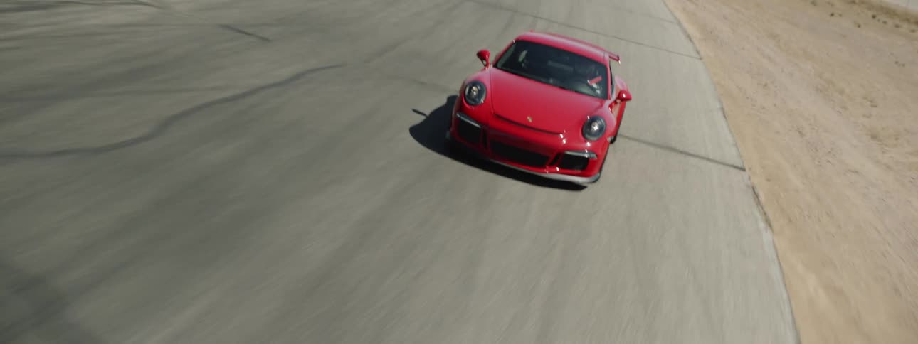 A man races his car on a track