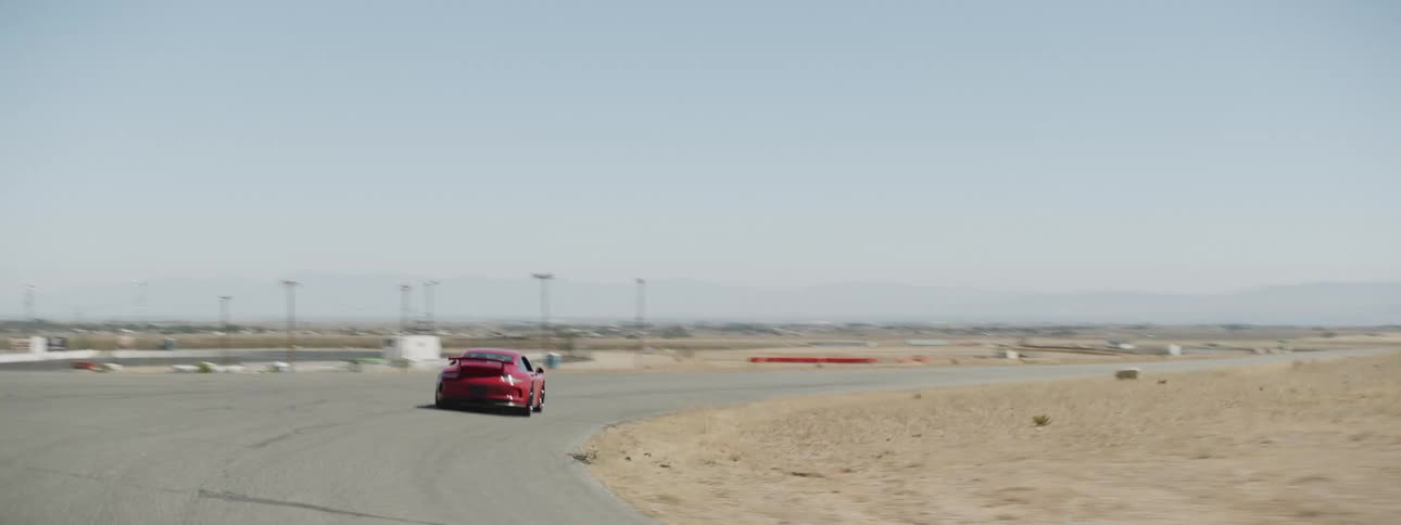 A person races a car around a track