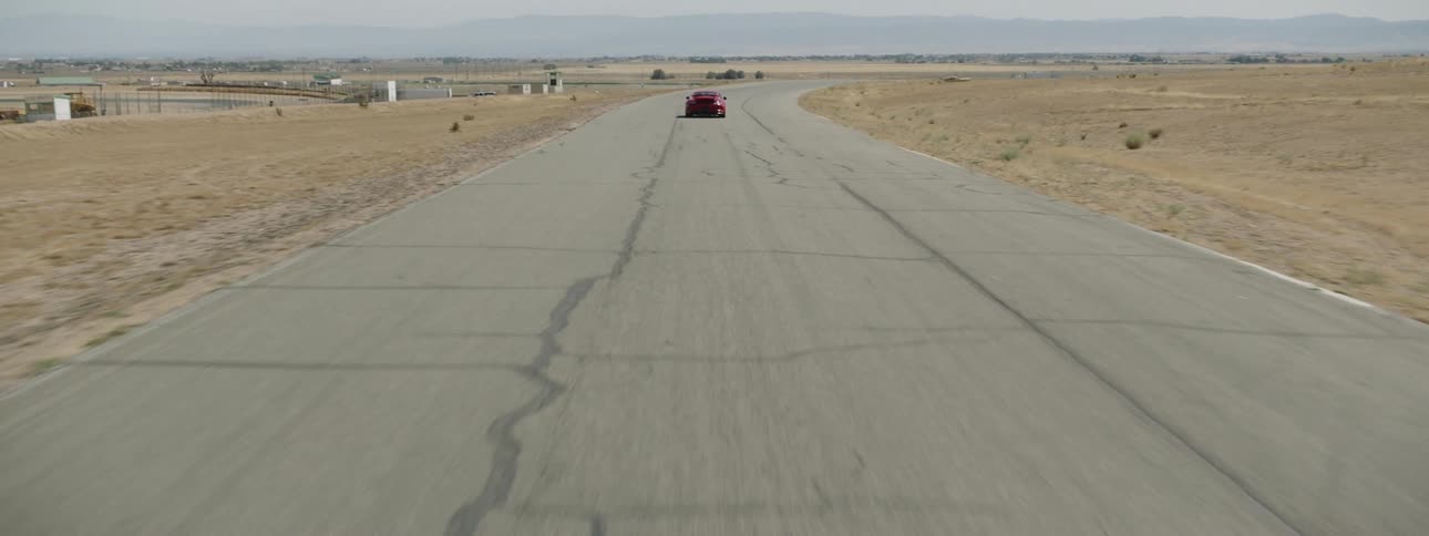 A red sports car driving on a track