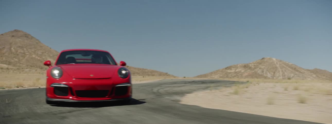 A red sports car driving on a track