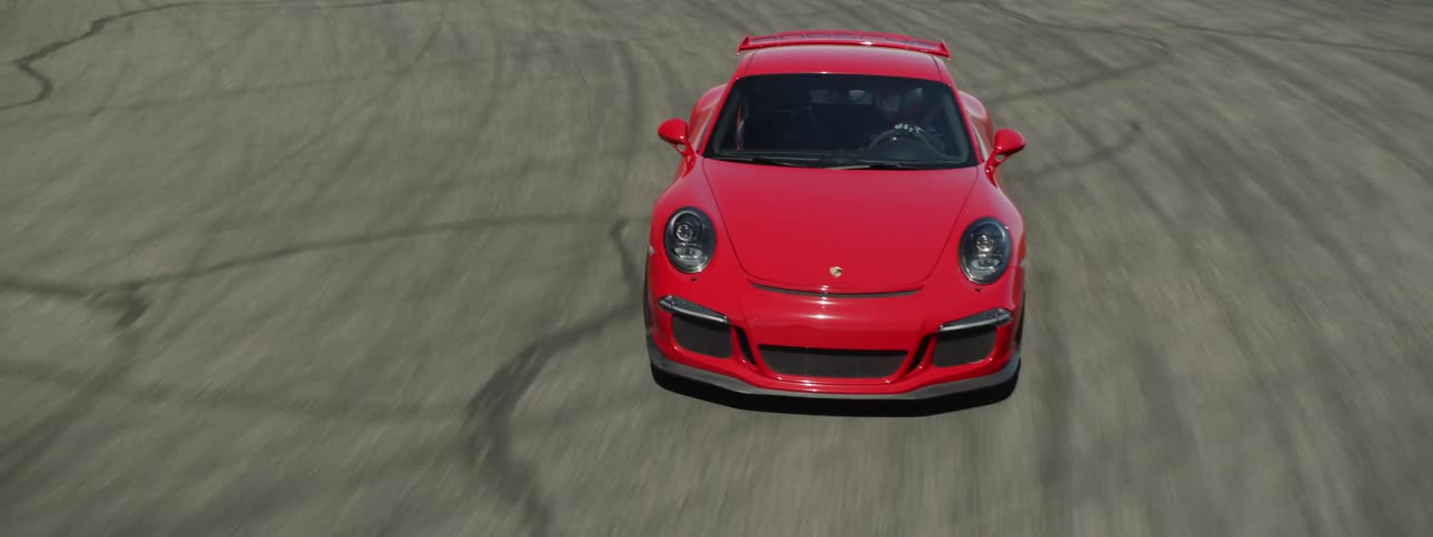 A red sports car driving on a track