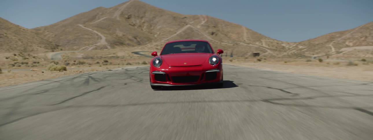 A person races their car around a road
