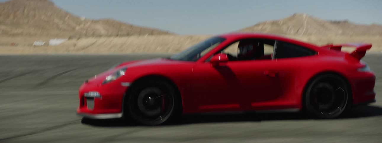 A red sports car driving on a track