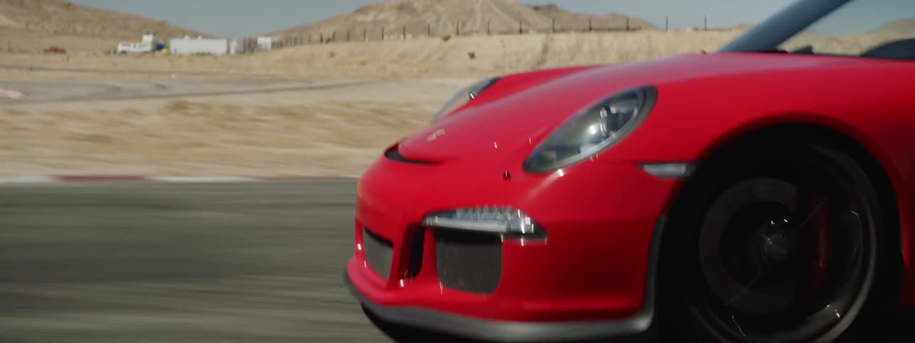 A red sports car driving on a track