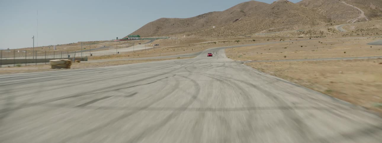 A red sports car driving on a track