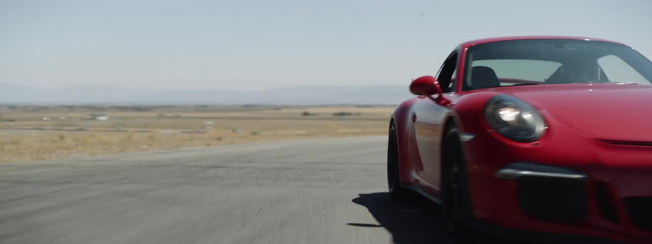 The car drives down the road