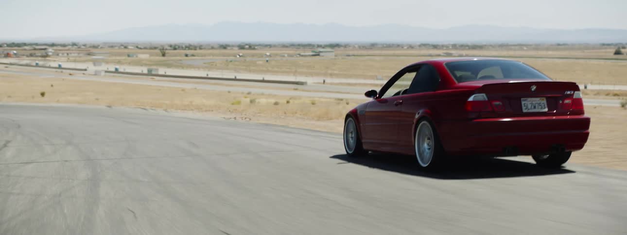 A red sports car driving on a track