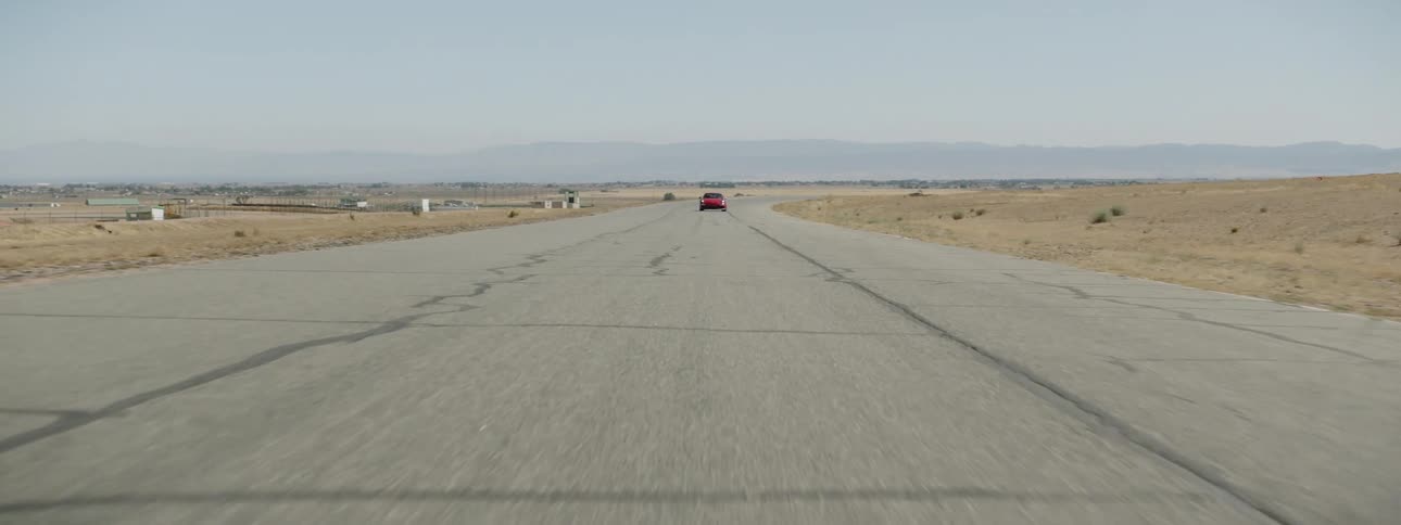 A red sports car driving on a track