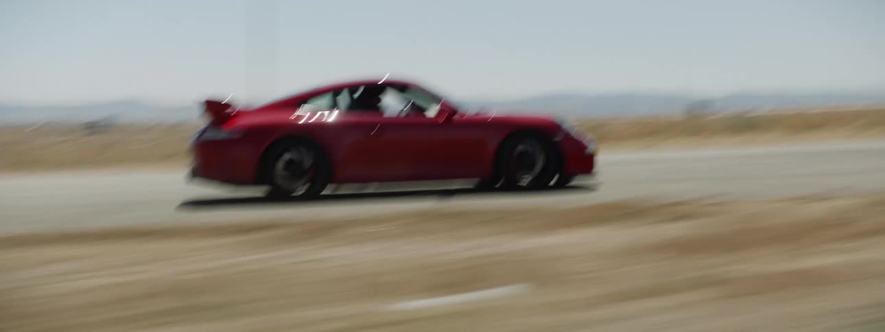 A person is racing a car in a desert area