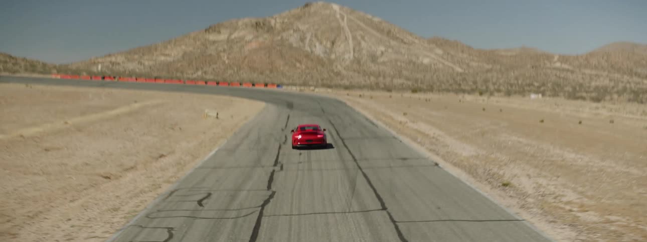 A red sports car driving on a track