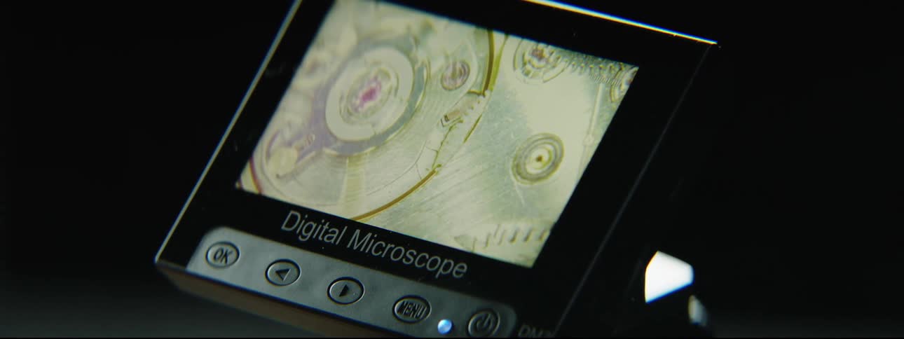 A digital microscope displays a moving and changing image on the screen
