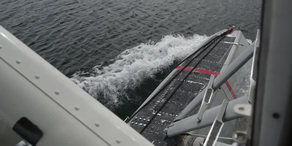 A vessel is sailing in the water producing waves