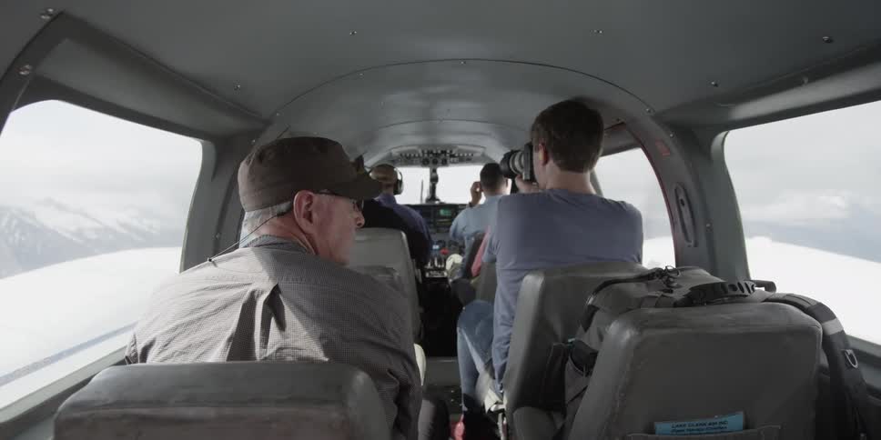 A group of people ride in a plane