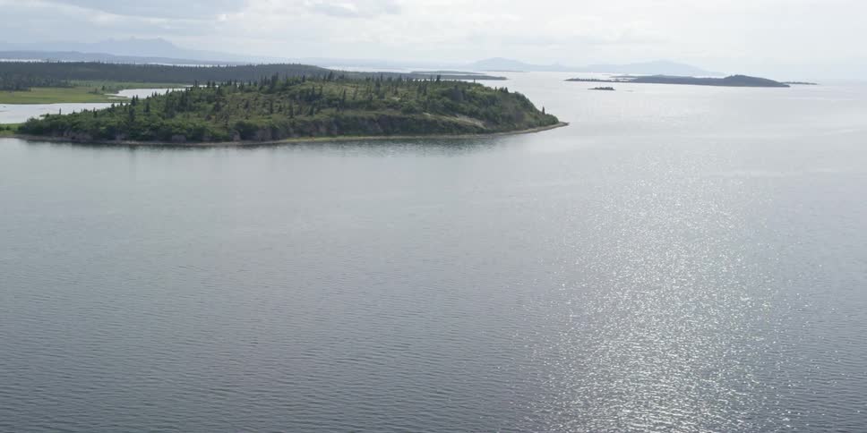 Aerial view of a lake with an island in the distance
