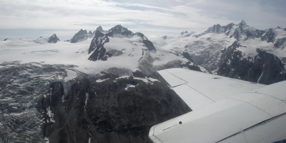 View from an airplane of snow covered mountains