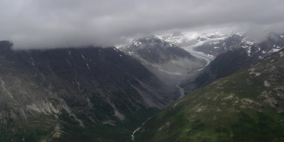 Aerial view of a stream running between two mountains