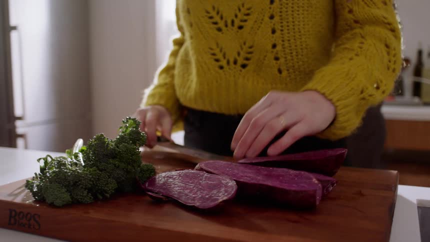 A man and a woman in a kitchen preparing food