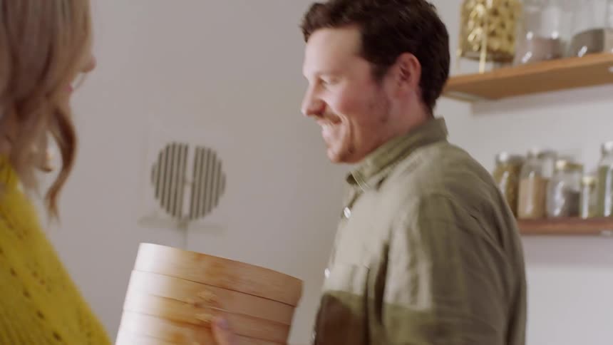 A man and woman cook together