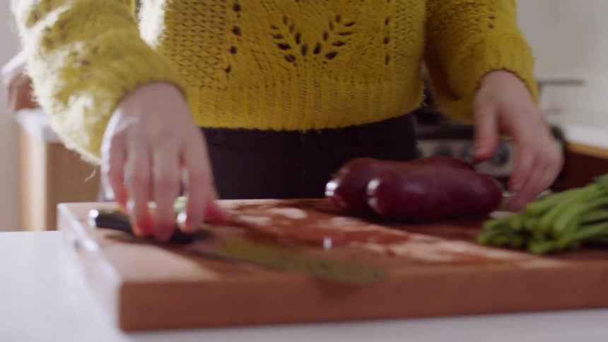 A man and woman working together to prepare a meal in their home kitchen