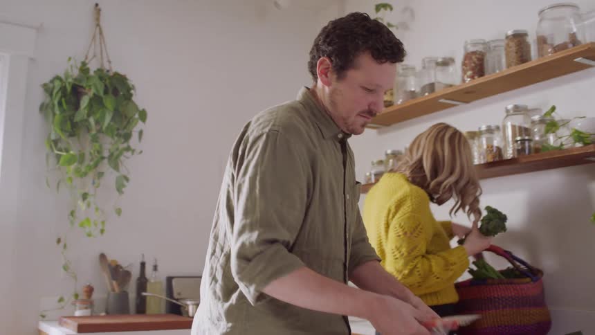 Couple preparing to cook a meal in their kitchen at home