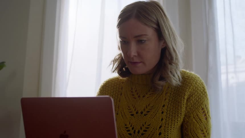 Woman using laptop at home