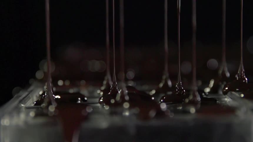 Chocolate sauce dripping in a studio