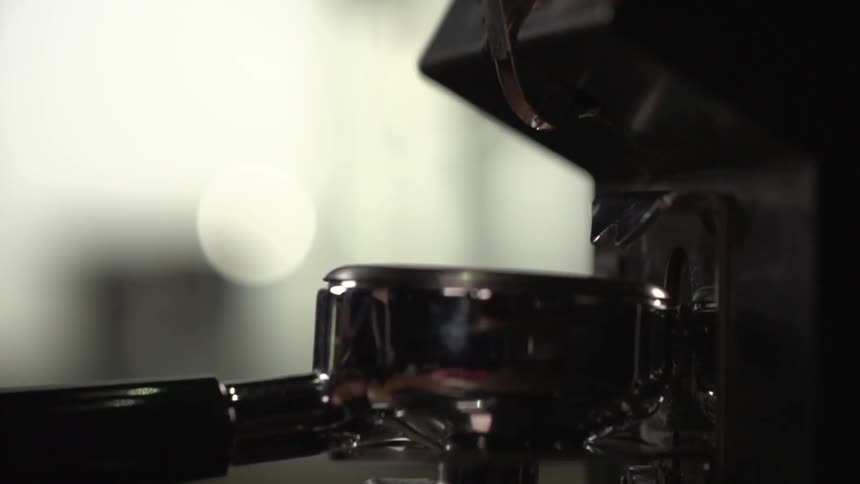 Coffee is prepared on a machine at a coffee shop