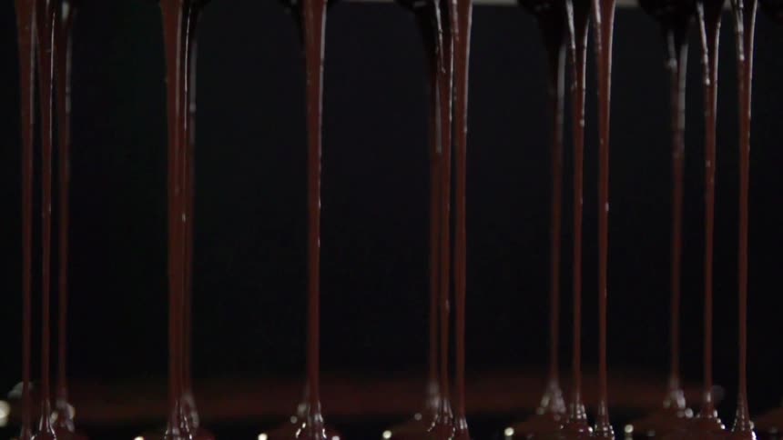 Melted chocolate pouring through machine