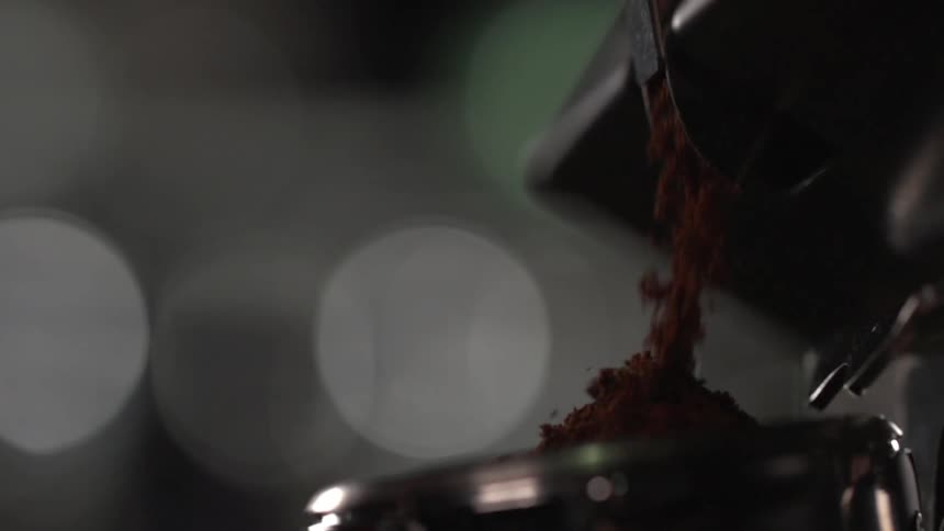 Pouring ground coffee into a container