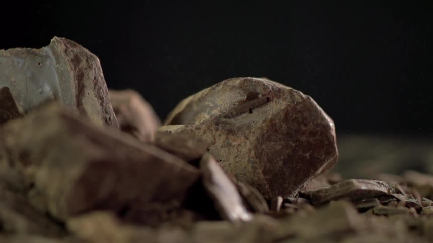 Big chunks of chocolate fall into a pile